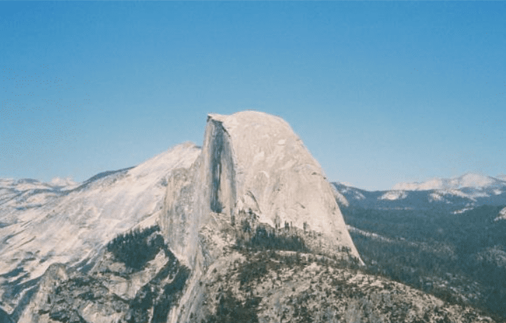 A mountain with snow on it's side.