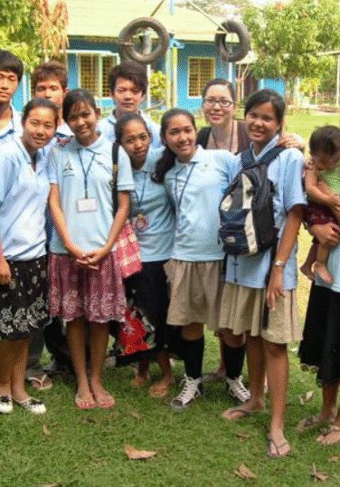 A group of people standing in the grass.